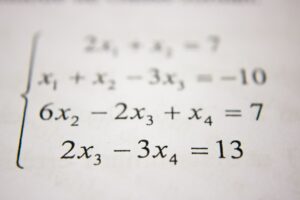close up of mathematical equations printed on white paper