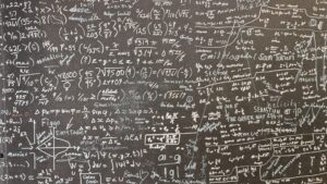 chalkboard covered in mathematical symbols